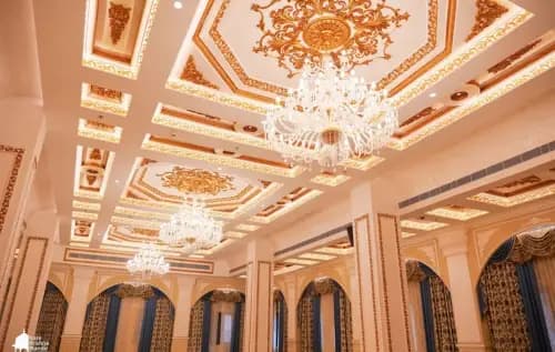 The golden coffered ceiling and chandeliers of Dwaraka Palace